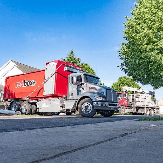redbox+ dumpster truck delivering to a residential roofing job in Austin